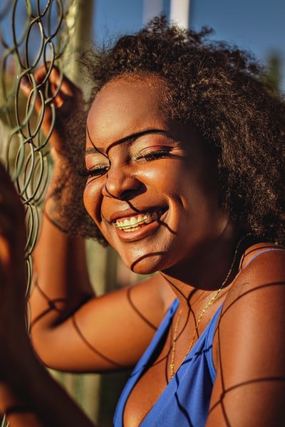 smiling woman in blue tank top